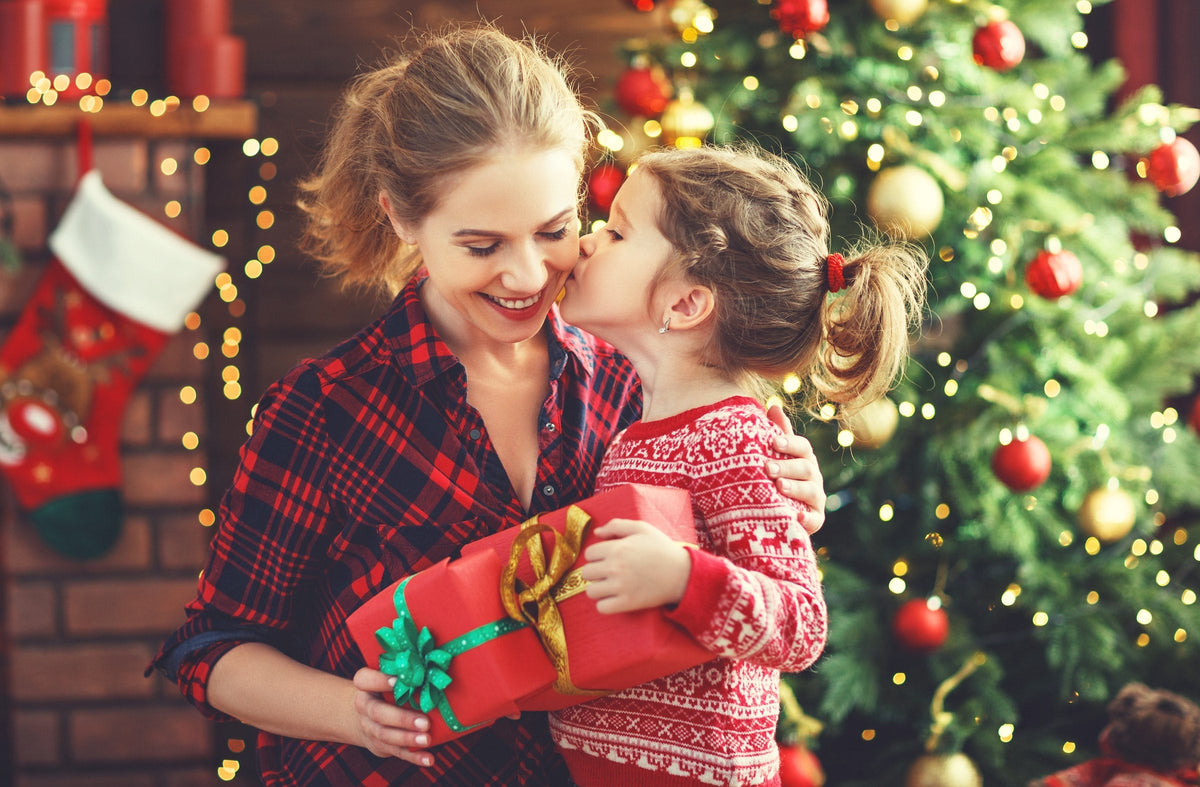 A mother and daughter exchanging a Christmas gift
