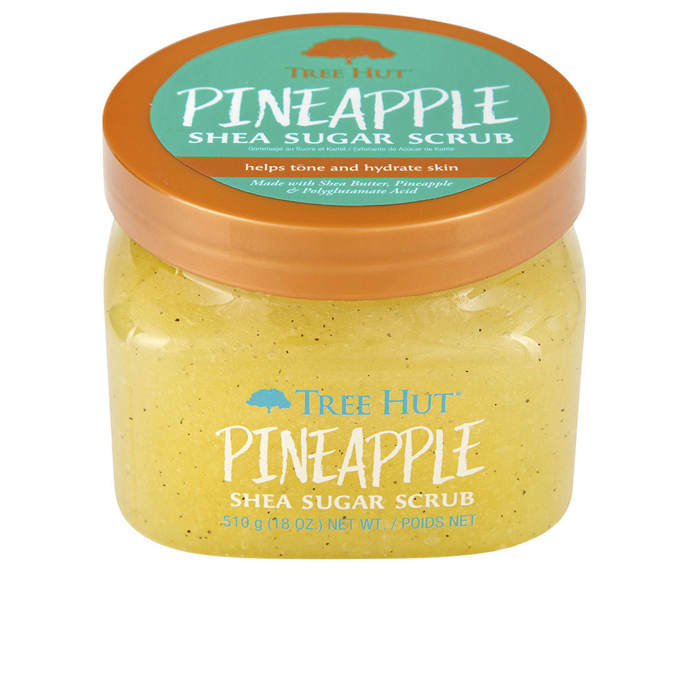 Jar of pineapple sugar body scrub with creamy texture and golden sugar crystals