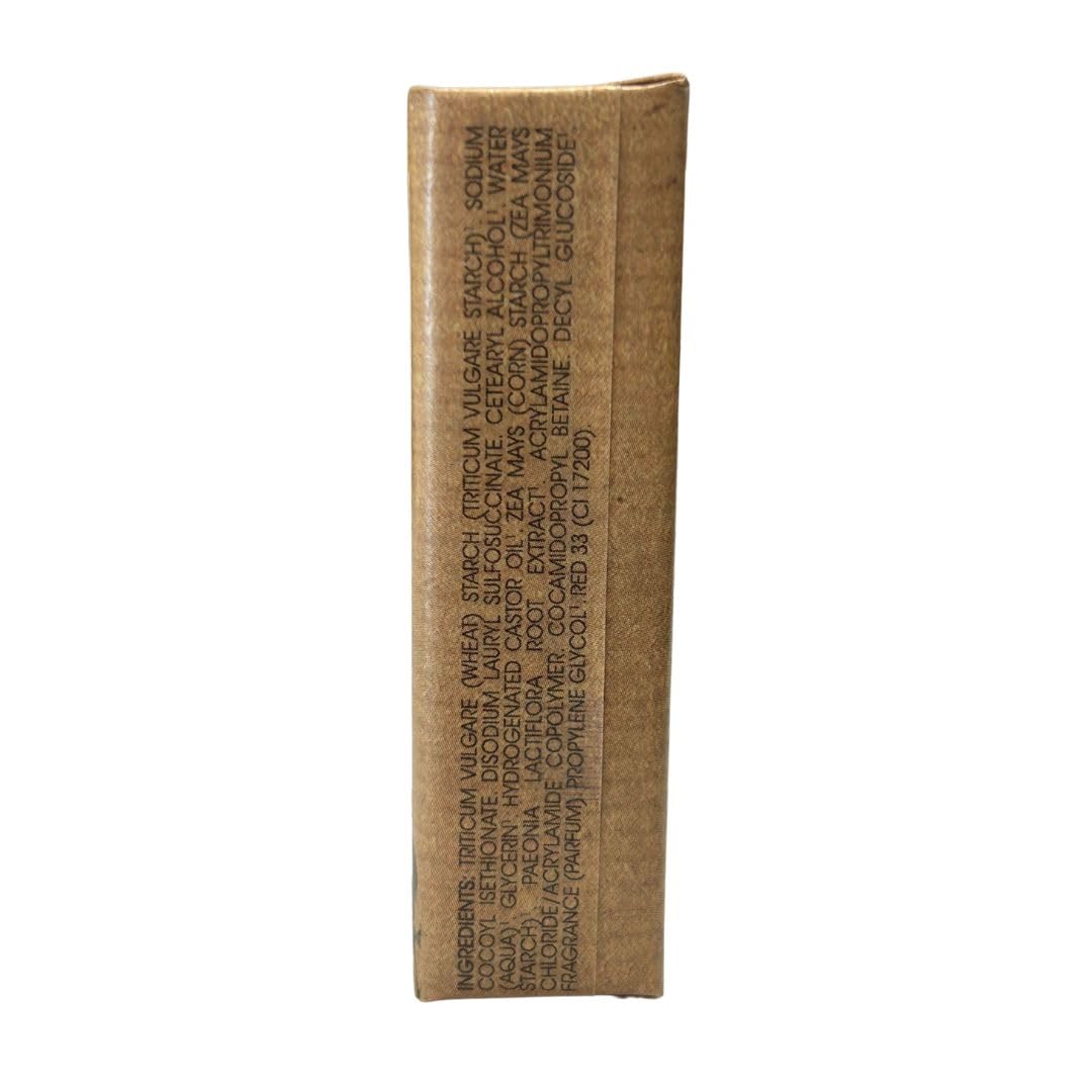 Klorane Brown rectangular shampoo bar in kraft paper with pink peony illustration, green accents, text labels, organic mark