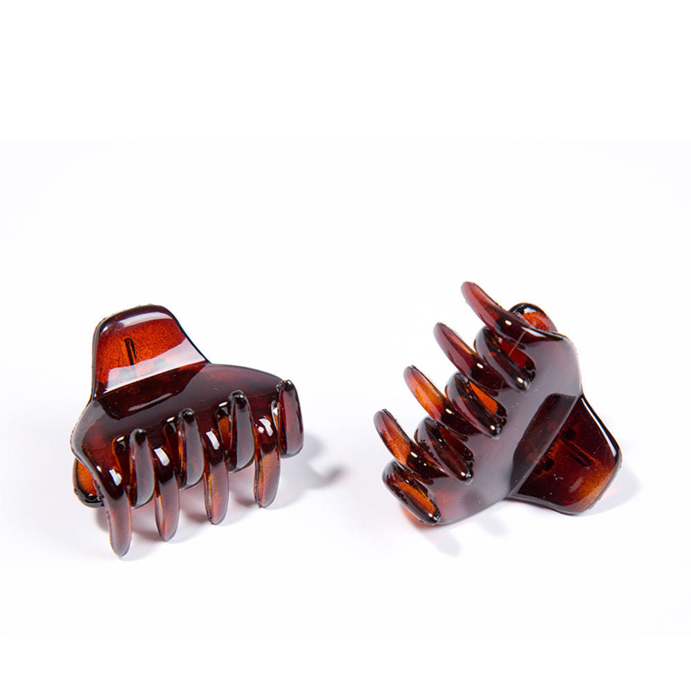 Two small brown plastic French-style hair claw clips with curved shape and claw teeth, Inca