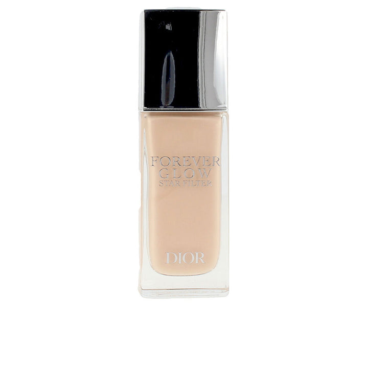 Small pump bottle of lightweight luminous fluid, pale champagne shade, liquid texture