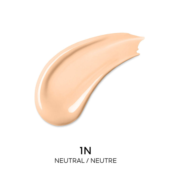 Guerlain Beige and dark brown liquid concealer in transparent cylindrical bottle with metallic cap and wand.