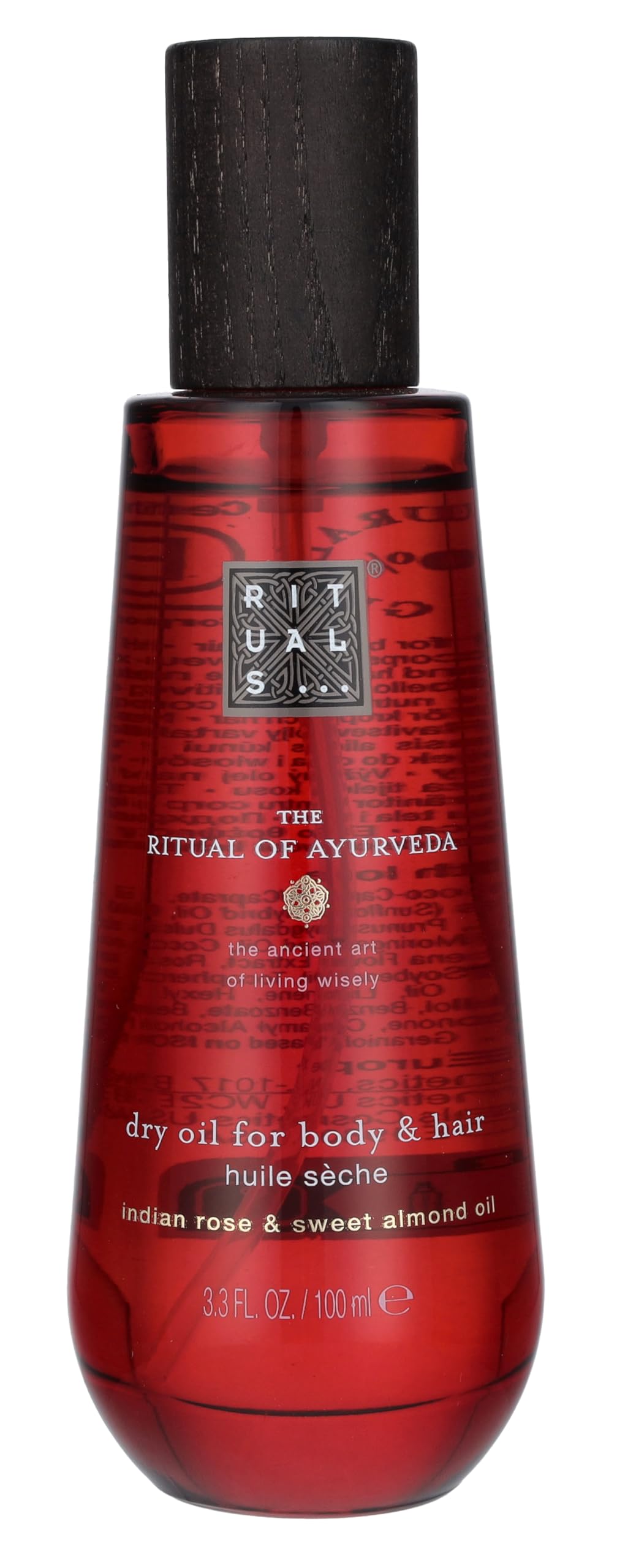 Glass bottle of Ayurvedic dry oil with amber liquid and minimalist label, Rituals branding visible