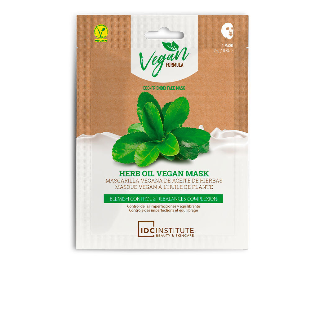 IDC Institute Brown, white, and green face mask packet with leaf image, vegan logo, and multilingual text