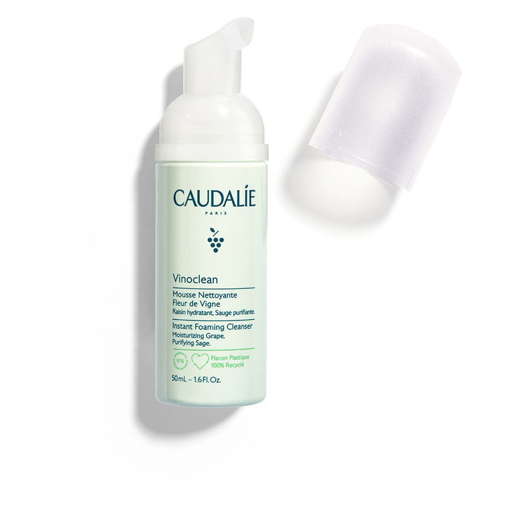 Caudalie Light green plastic foaming cleanser bottle with pump, removable clear cap, printed text and compact size