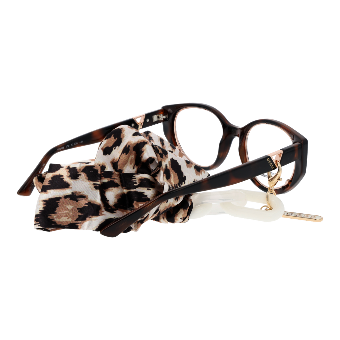 Tortoise cat-eye eyeglasses with gold temple accents and detachable leopard-print scarf on white background