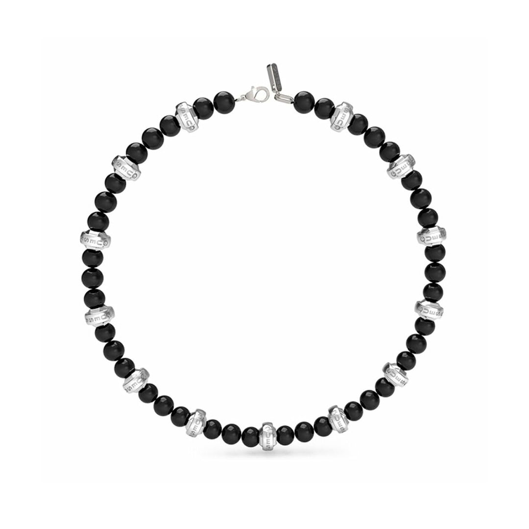 Black round beaded necklace with engraved silver spacer beads and lobster clasp laid flat on dark background