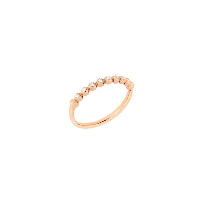 Delicate rose gold ring with embedded clear diamonds on a minimalist white background