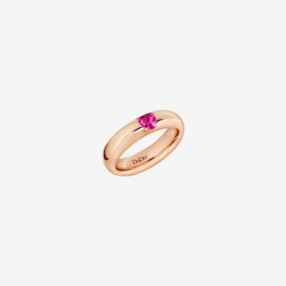 Rose gold ring featuring a pink faceted gemstone set in four prongs on a polished band