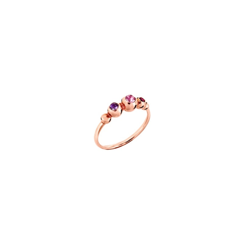 Close-up of rose gold ring featuring pink and purple gemstone accents on a delicate band
