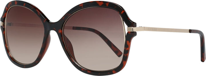 Oversized tortoise shell sunglasses with brown gradient lenses and slim metal temples on white background